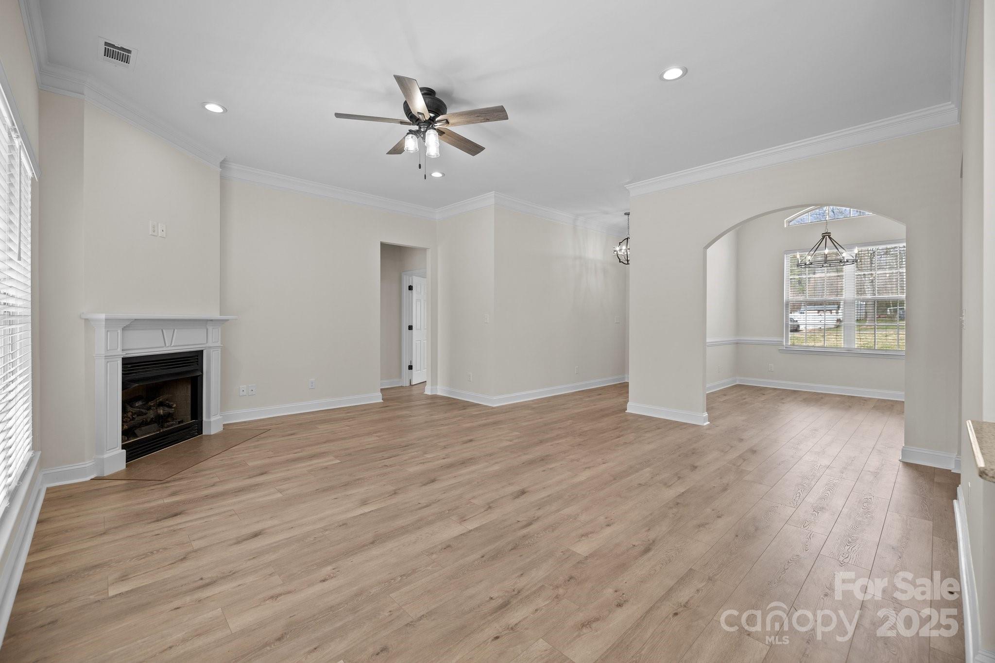 910 Pine Knoll Road, Unit 13 Fort Mill, SC 29715 - Photo 8 of 37 a view of empty room with wooden floor and fireplace