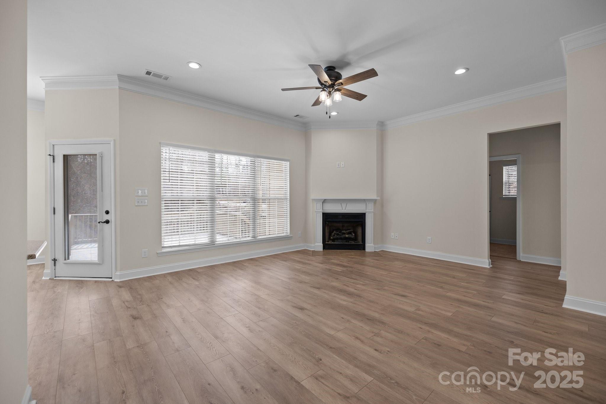 910 Pine Knoll Road, Unit 13 Fort Mill, SC 29715 - Photo 10 of 37 a view of an empty room with wooden floor and a window