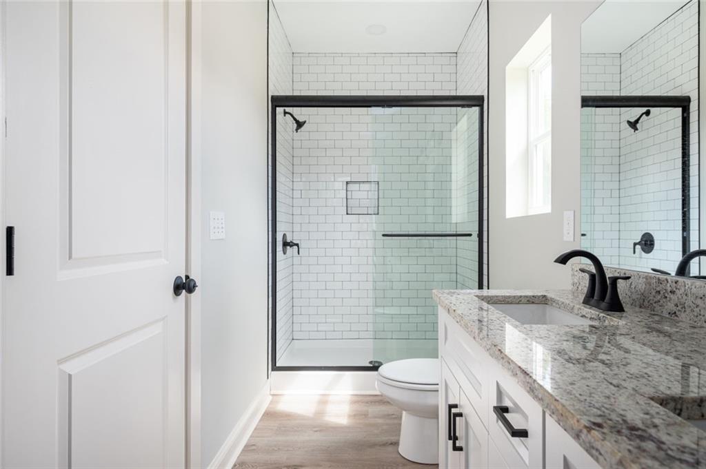 371 C W Sims Road Hiram, GA 30141 - Photo 10 of 12 a bathroom with a granite countertop sink toilet and shower