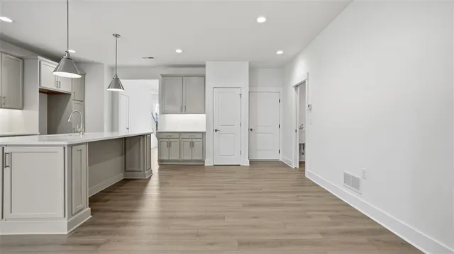 a view of a kitchen with wooden floor and a kitchen
