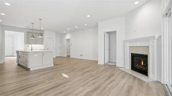 a view of kitchen with granite countertop kitchen island wooden floor center island and stainless steel appliances