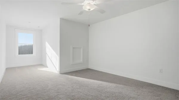 an empty room with a ceiling fan and window