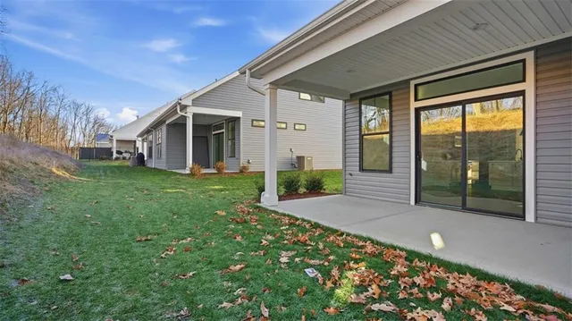 a view of a house with a big yard and potted plants