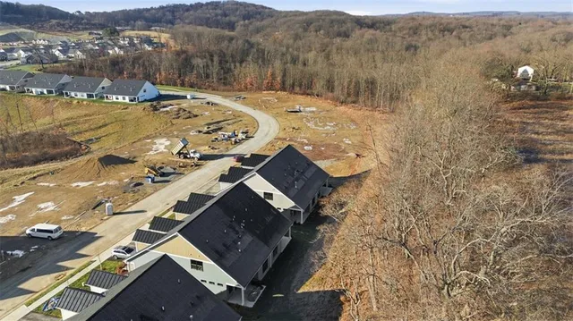 an aerial view of residential houses with outdoor space