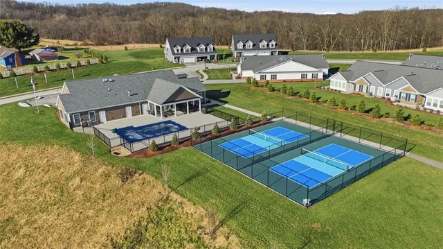 an aerial view of residential houses with outdoor space and city view
