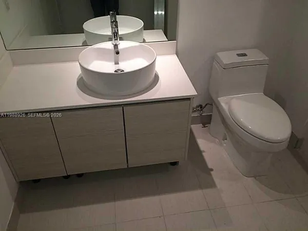 a bathroom with a toilet and a mirror