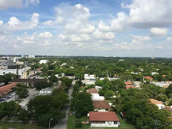 an aerial view of residential houses with city view