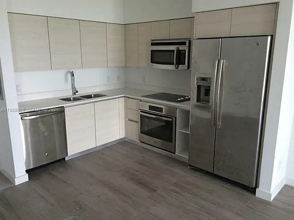 a kitchen with a sink stainless steel appliances and cabinets