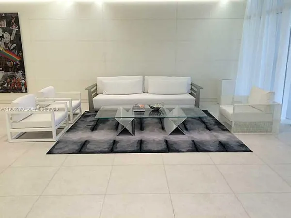 a bedroom with a bed and a rug