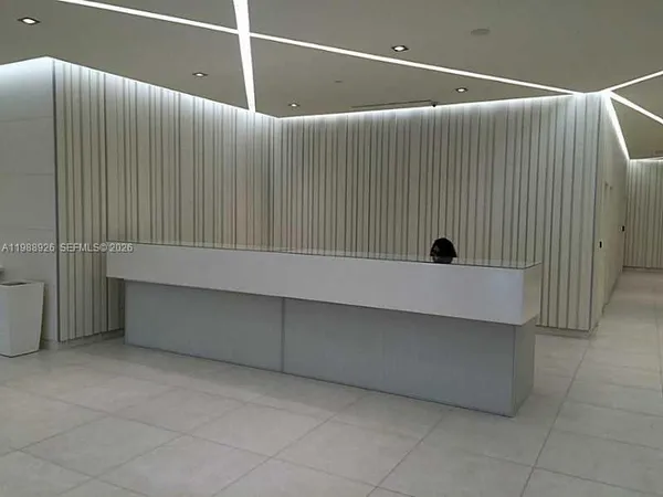 a dining room with furniture and white walls