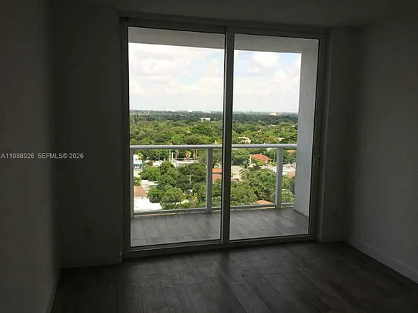 a view of a large window with wooden floor in a room