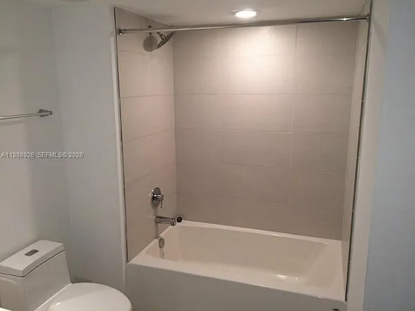 a bathroom with a bathtub and a toilet