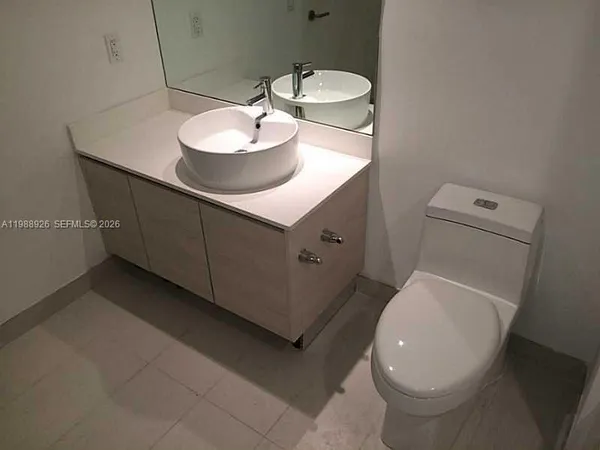 a bathroom with a sink toilet and a mirror