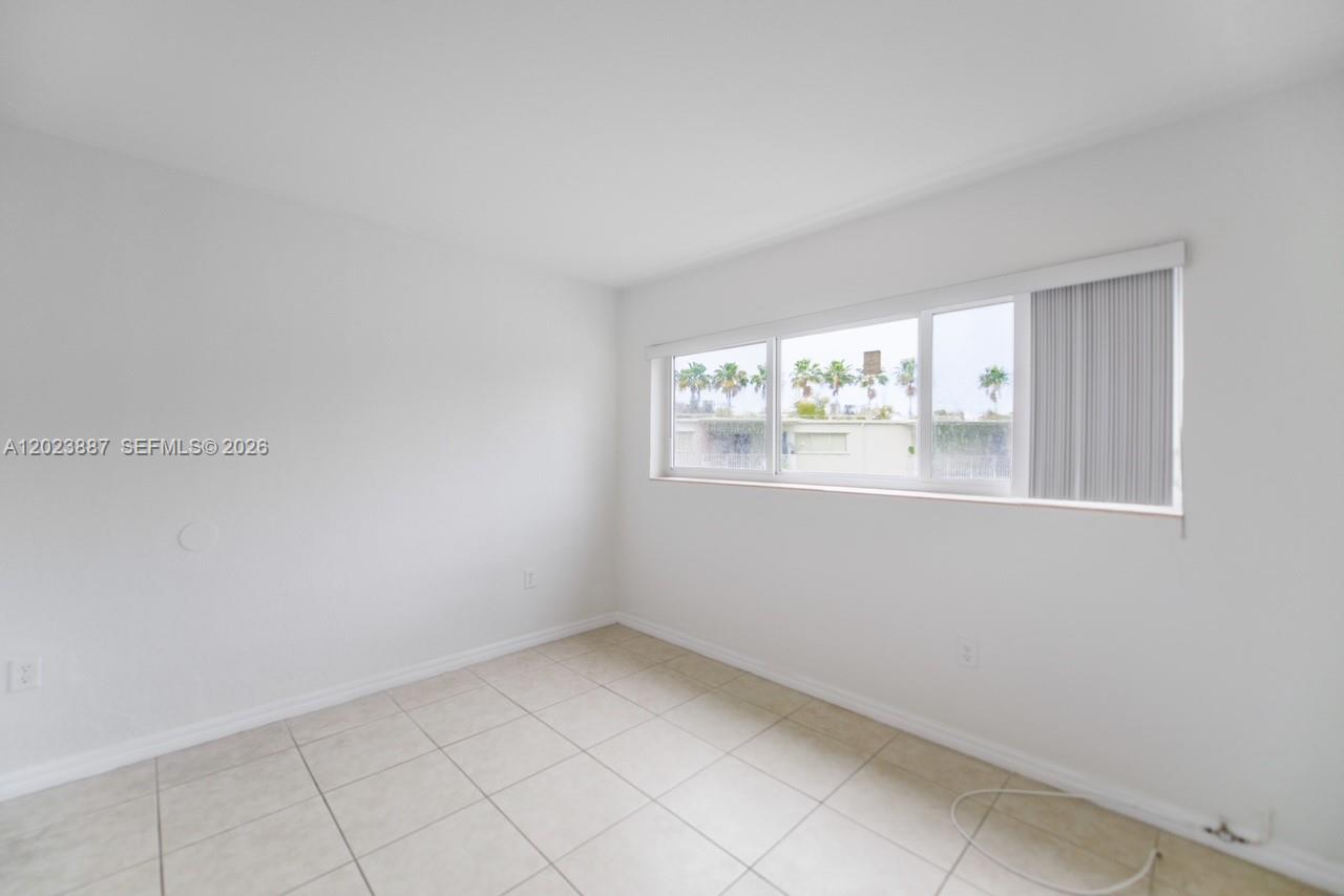 7737 Southwest 88th Street, Unit C312 Miami, FL 33156 - Photo 20 of 32 a view of an empty room with a window