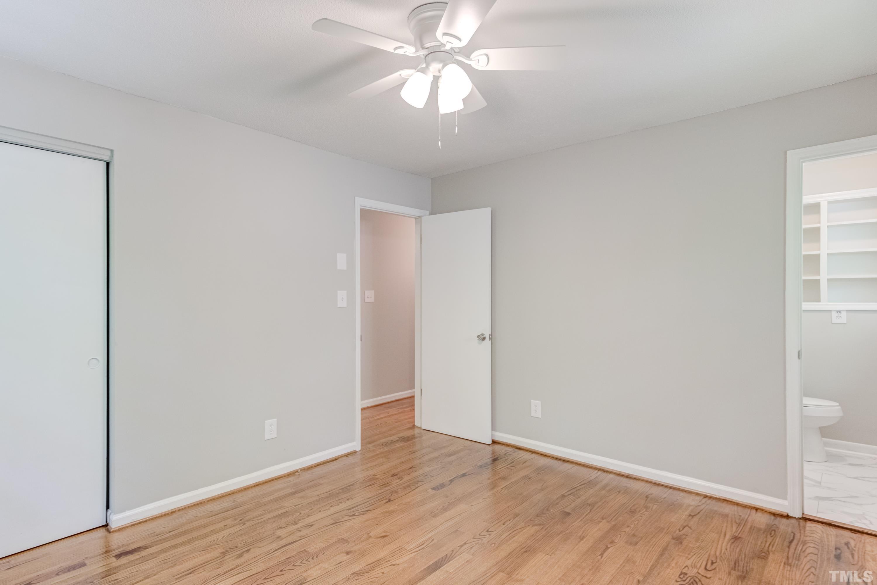 6005 Meadowbrook Road Raleigh, NC 27603 - Photo 20 of 42 a view of an empty room and window and wooden floor