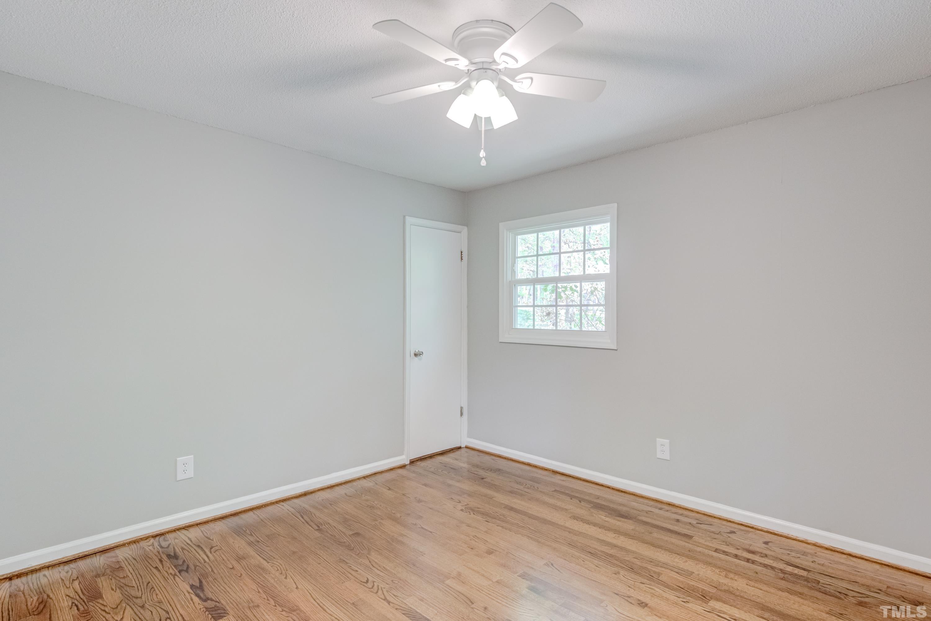 6005 Meadowbrook Road Raleigh, NC 27603 - Photo 21 of 42 wooden floor in an empty room with a window