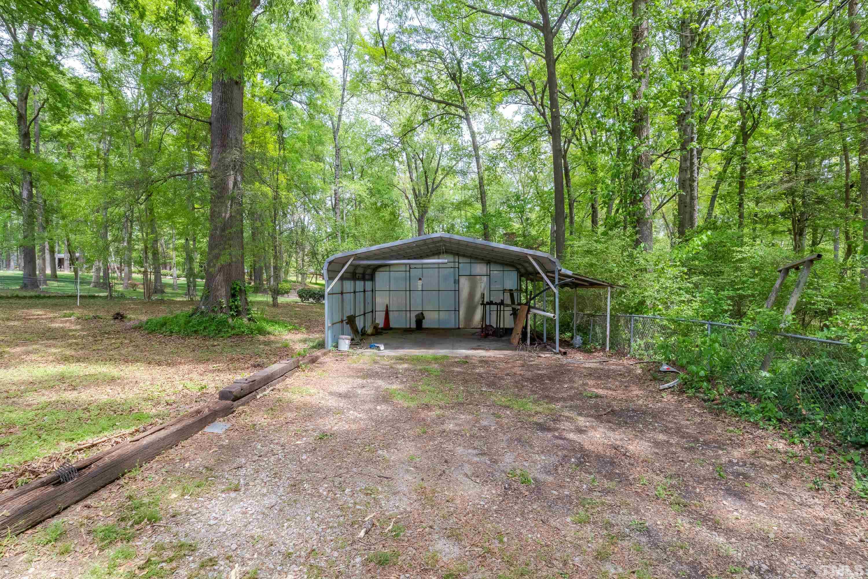 6005 Meadowbrook Road Raleigh, NC 27603 - Photo 29 of 42 a yellow house in middle of the forest