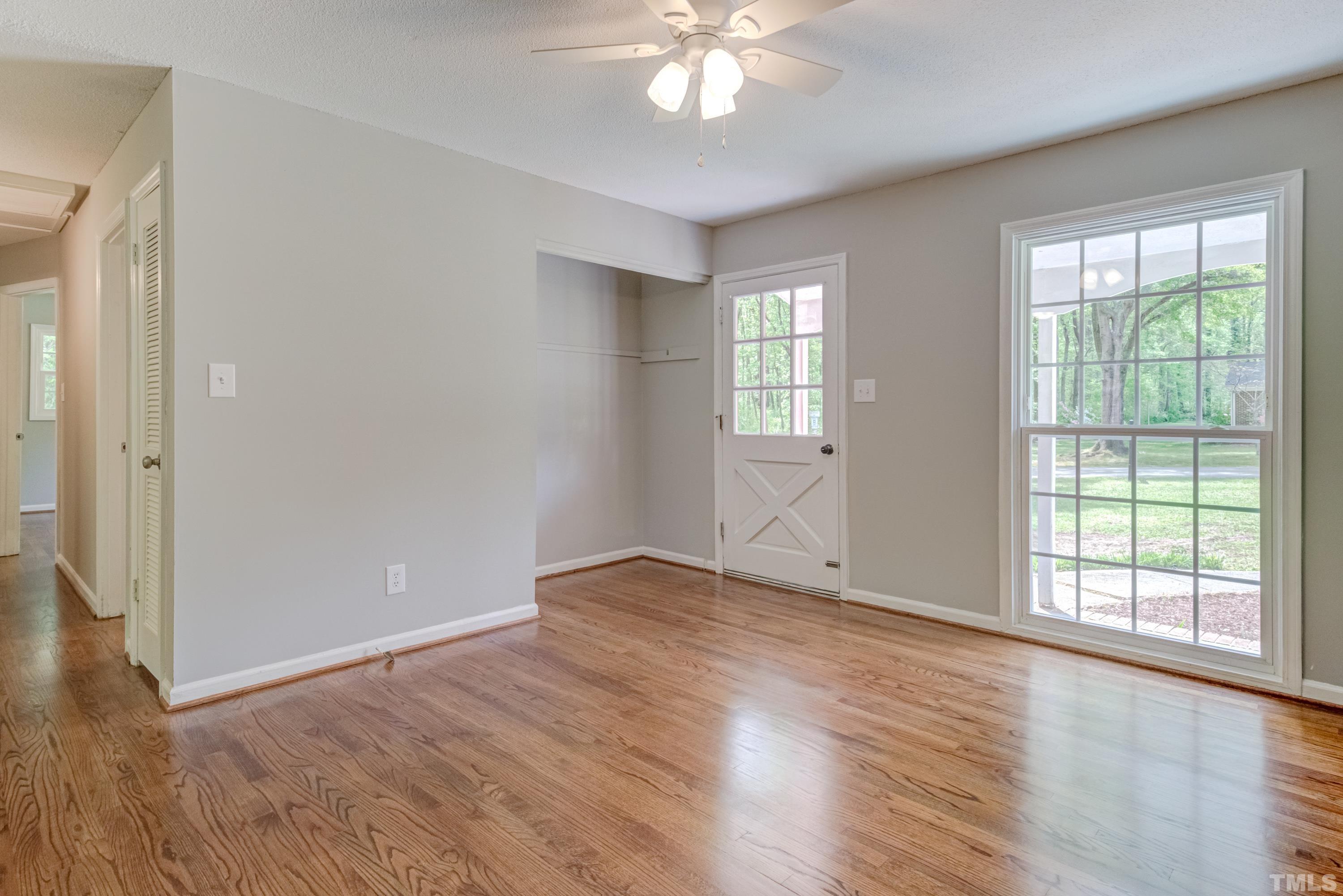 6005 Meadowbrook Road Raleigh, NC 27603 - Photo 4 of 42 a view of an empty room with wooden floor and a window