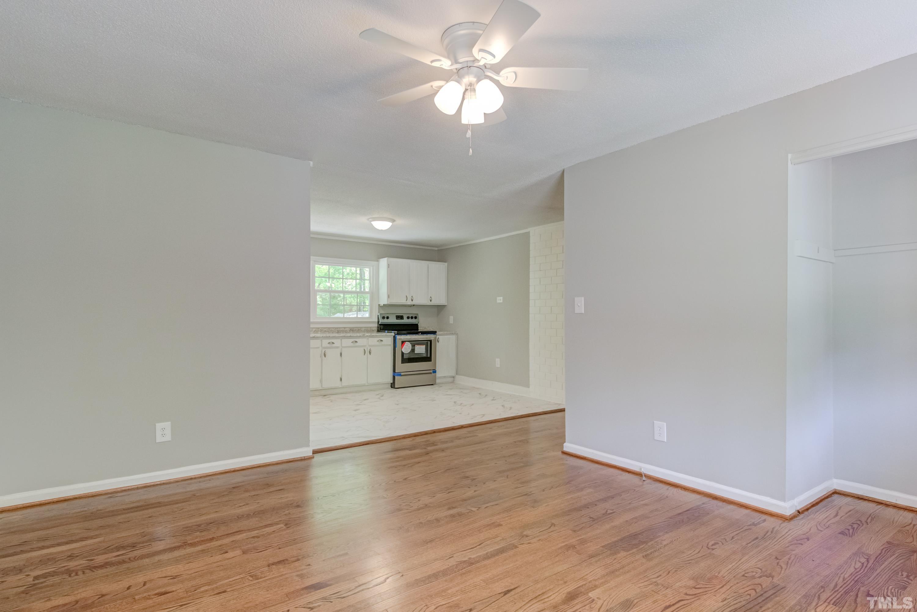 6005 Meadowbrook Road Raleigh, NC 27603 - Photo 5 of 42 a view of a kitchen with a sink and a chandelier fan