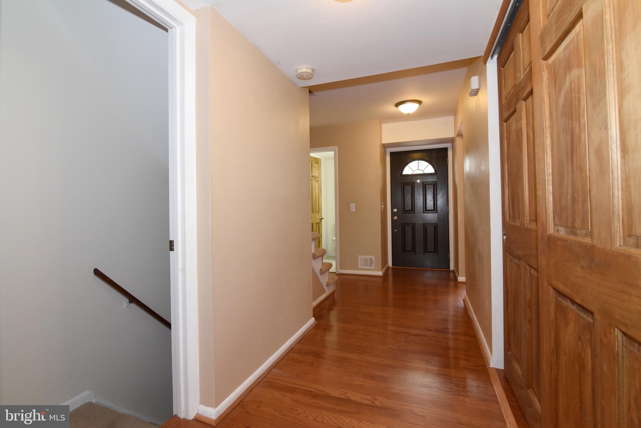 2334 Generation Drive Reston, VA 20191 - Photo 26 of 55 a view of a hallway with wooden floor and staircase