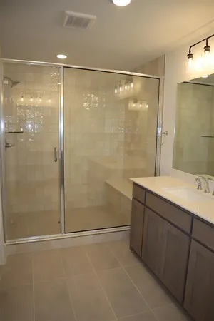 a bathroom with a shower and a sink