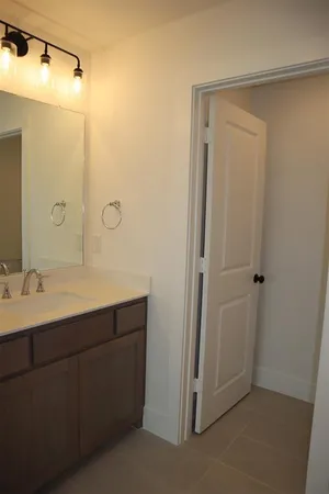 a bathroom with a double vanity sink mirror and shower