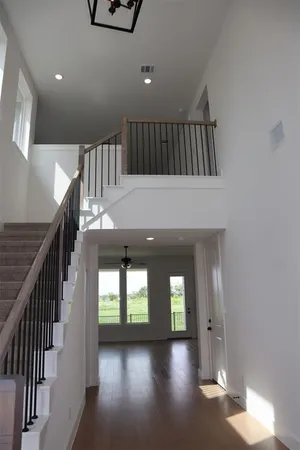 a view of entryway and hall with wooden floor