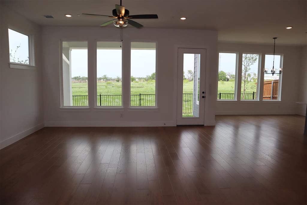 205 Chestnut Celina, TX 75009 - Photo 4 of 19 an empty room with wooden floor and windows