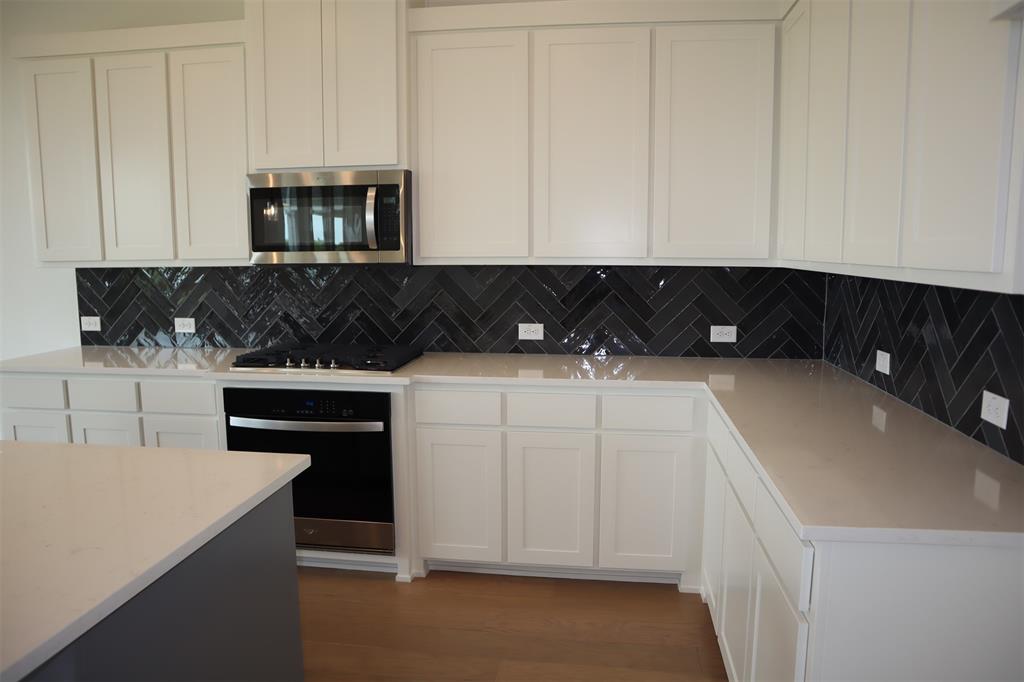 205 Chestnut Celina, TX 75009 - Photo 7 of 19 a kitchen with a sink and cabinets