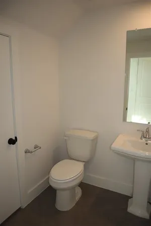a white toilet sitting next to a bathroom sink