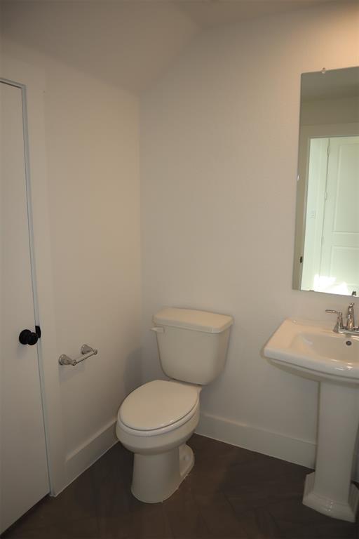 205 Chestnut Celina, TX 75009 - Photo 9 of 19 a white toilet sitting next to a bathroom sink