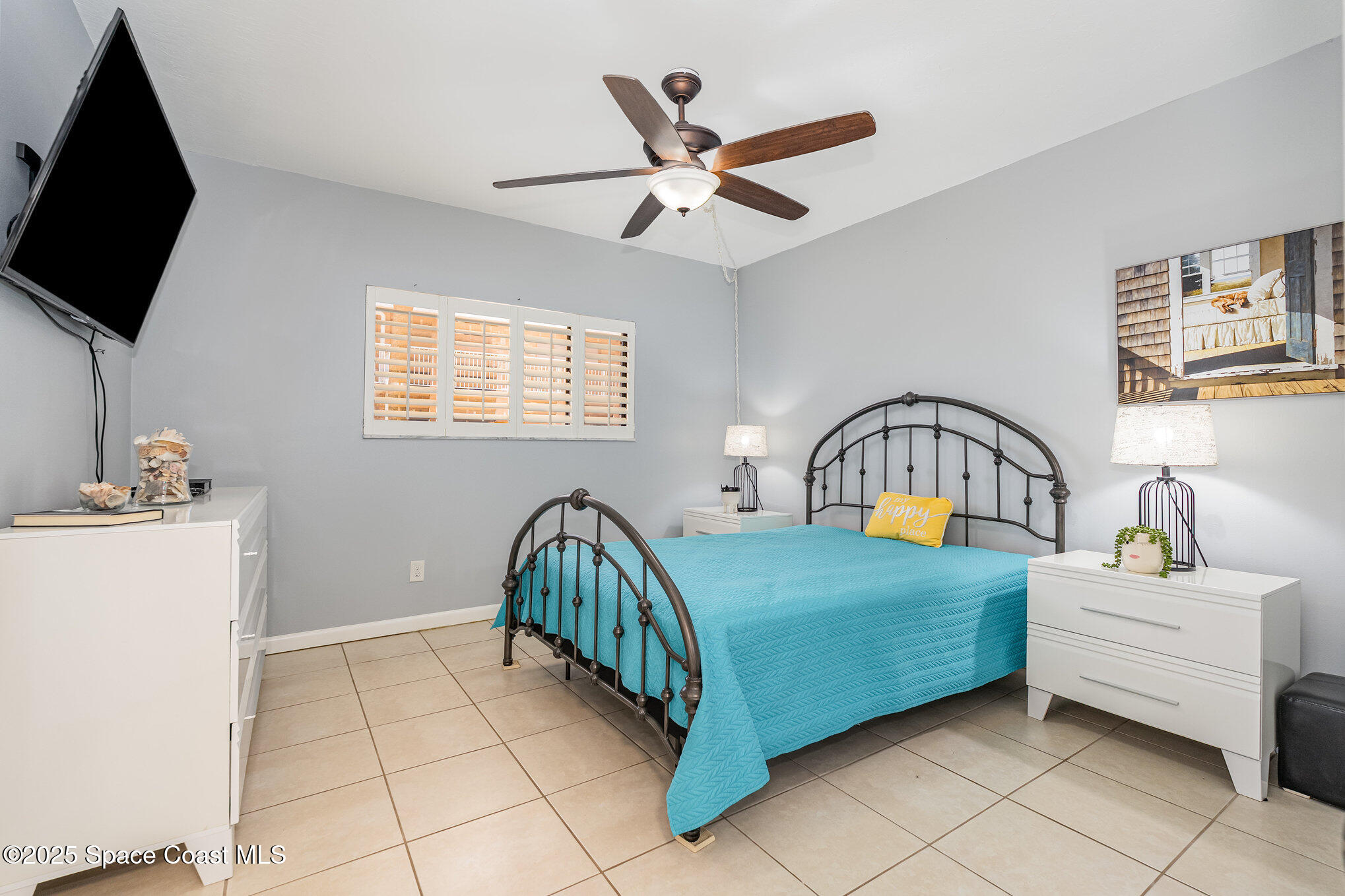 5000 Ocean Beach Boulevard, Unit C5 Cocoa Beach, FL 32931 - Photo 11 of 31 a bedroom with a bed a flat screen tv and a window
