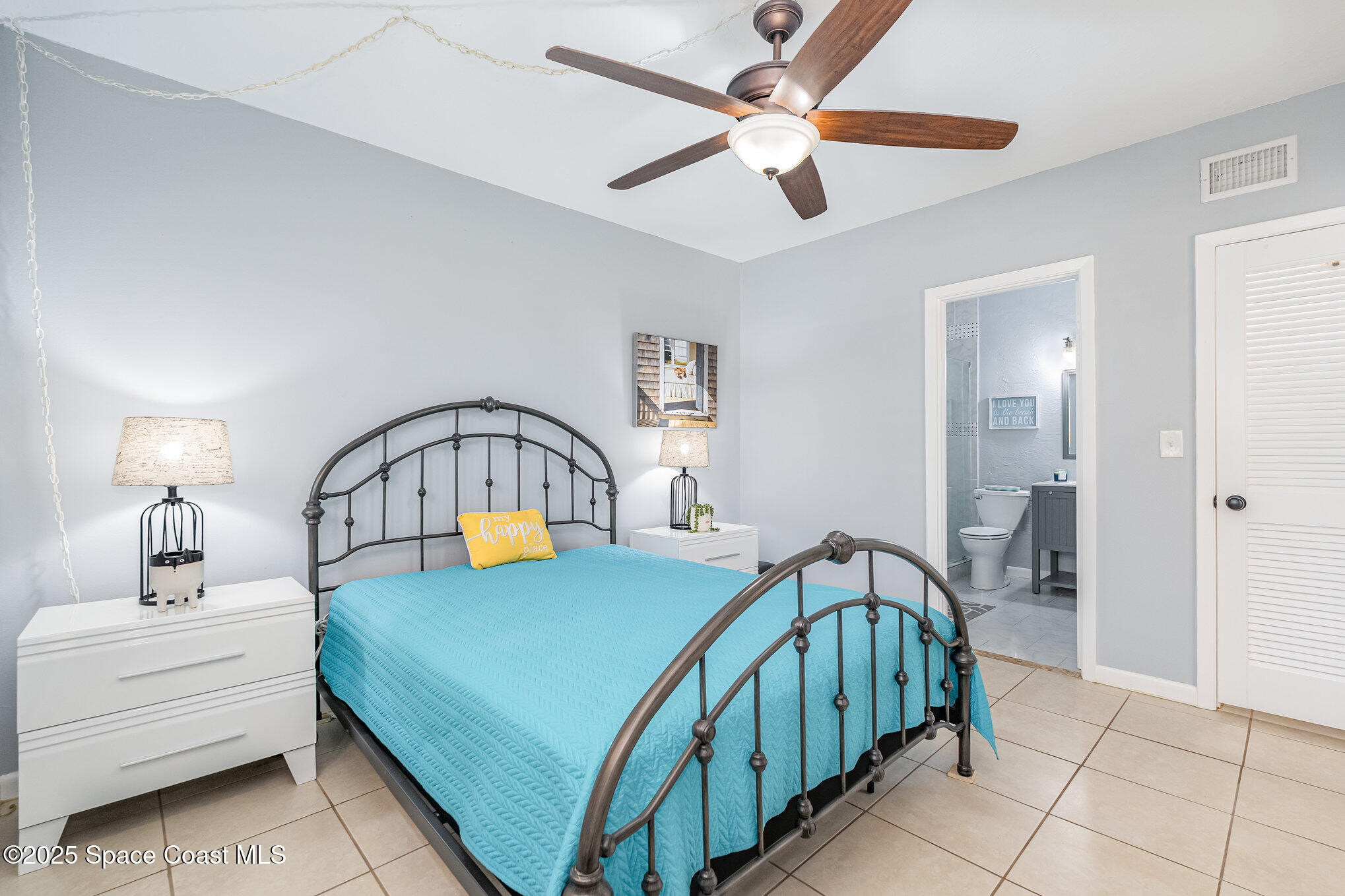5000 Ocean Beach Boulevard, Unit C5 Cocoa Beach, FL 32931 - Photo 12 of 31 a bedroom with a bed and a chandelier