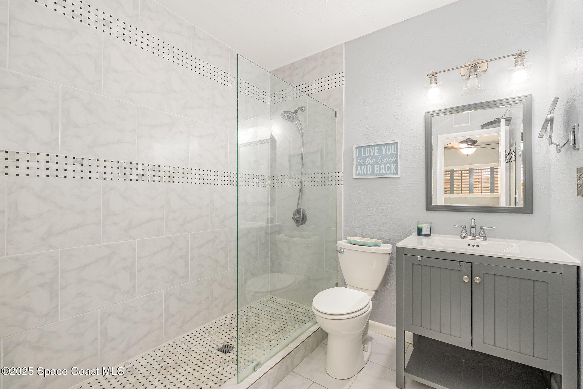 5000 Ocean Beach Boulevard, Unit C5 Cocoa Beach, FL 32931 - Photo 13 of 31 a bathroom with a toilet sink and shower