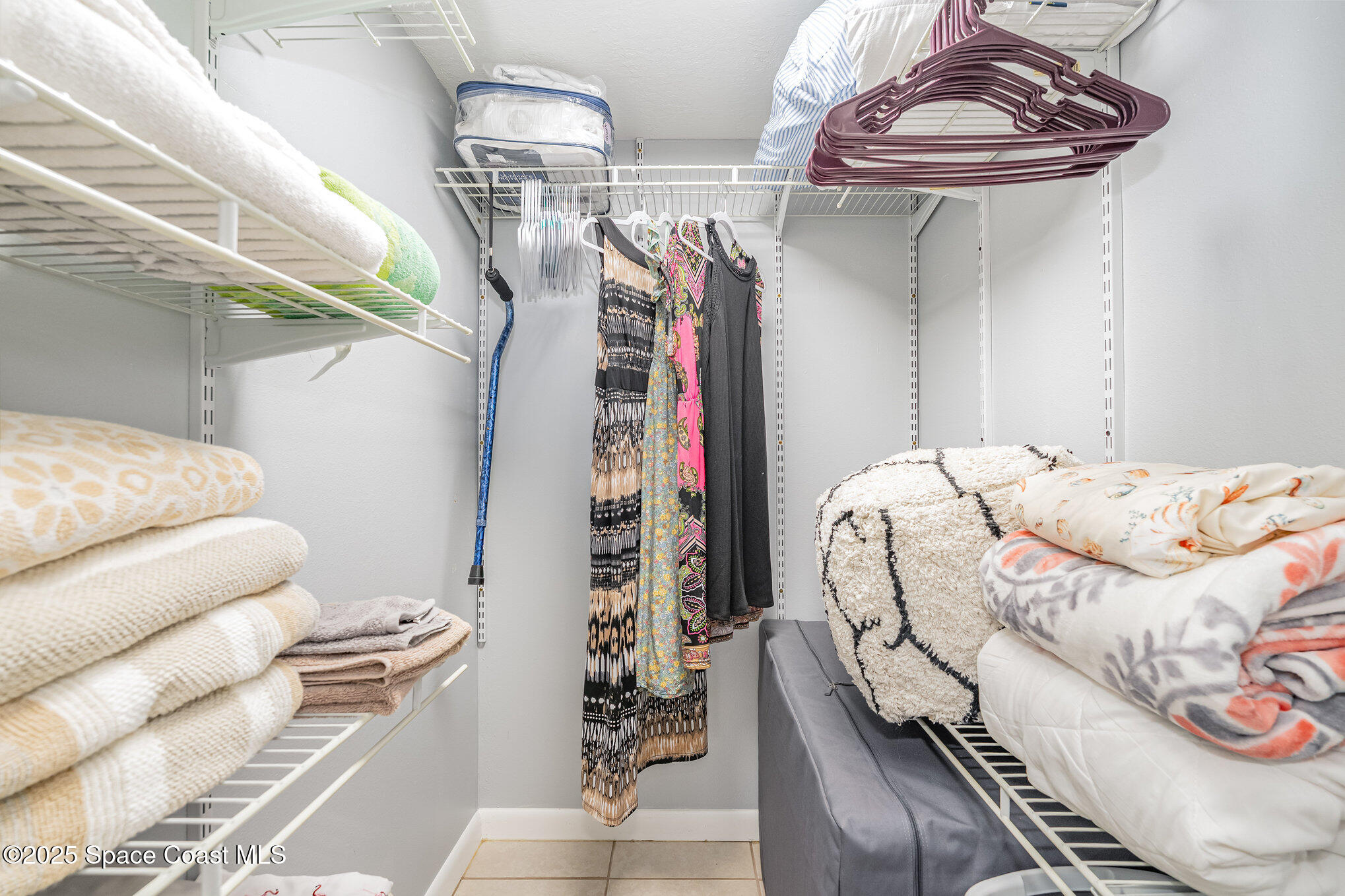 5000 Ocean Beach Boulevard, Unit C5 Cocoa Beach, FL 32931 - Photo 14 of 31 a bedroom with a bed and a chandelier