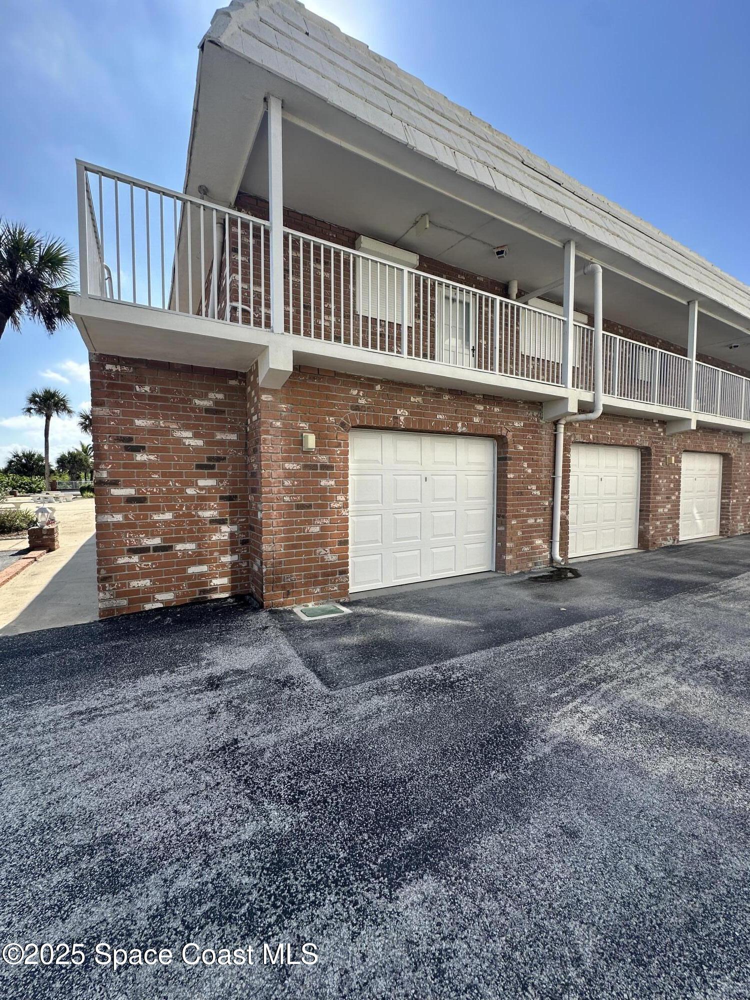 5000 Ocean Beach Boulevard, Unit C5 Cocoa Beach, FL 32931 - Photo 18 of 31 a view of a house with a yard