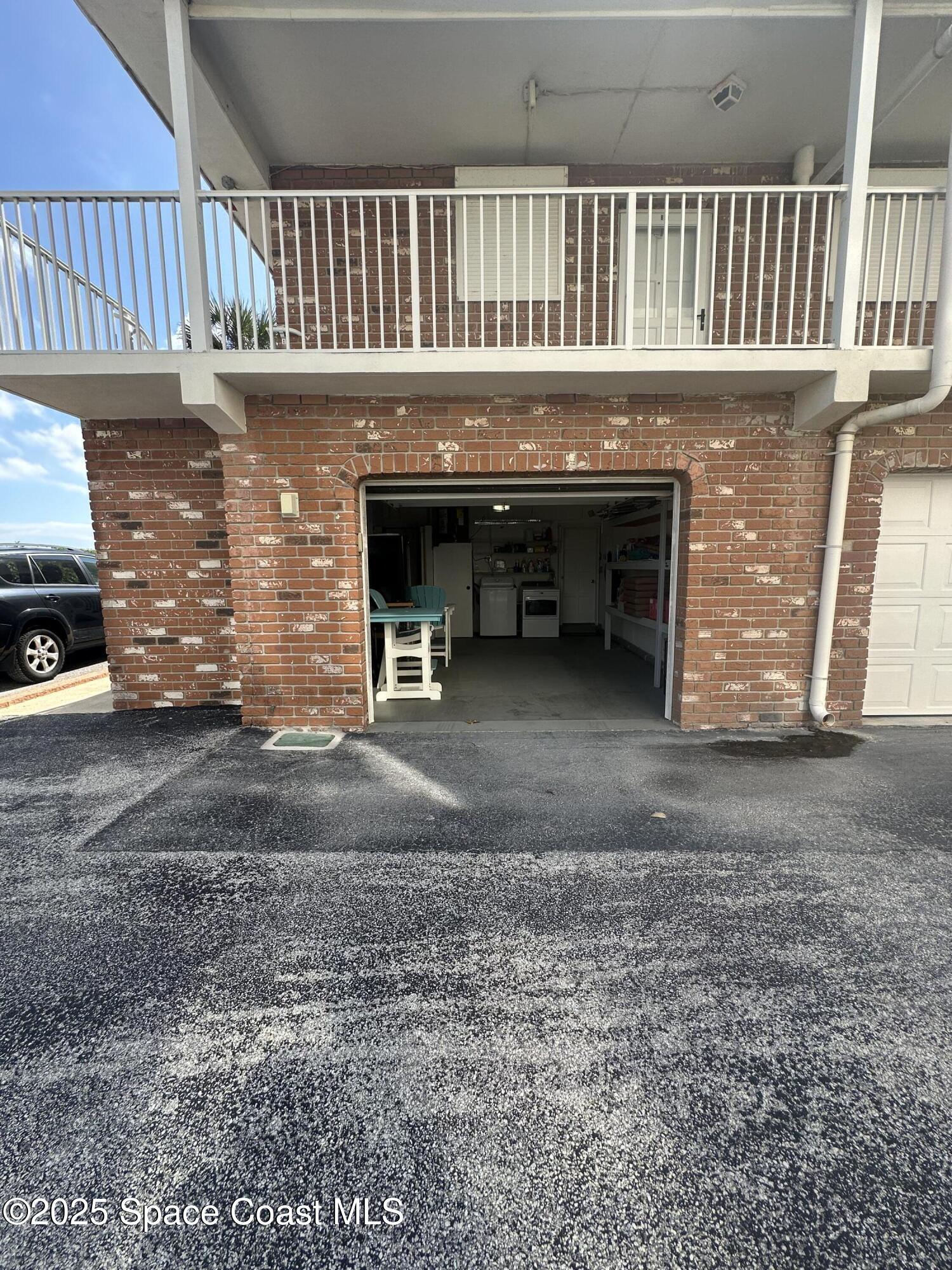 5000 Ocean Beach Boulevard, Unit C5 Cocoa Beach, FL 32931 - Photo 21 of 31 a view of an empty room with wooden floor and a fireplace