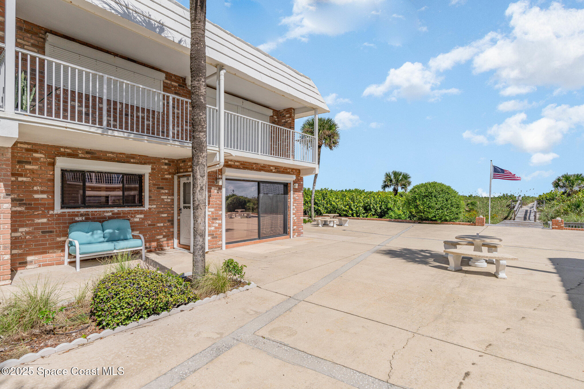 5000 Ocean Beach Boulevard, Unit C5 Cocoa Beach, FL 32931 - Photo 25 of 31 a view of a building with a yard
