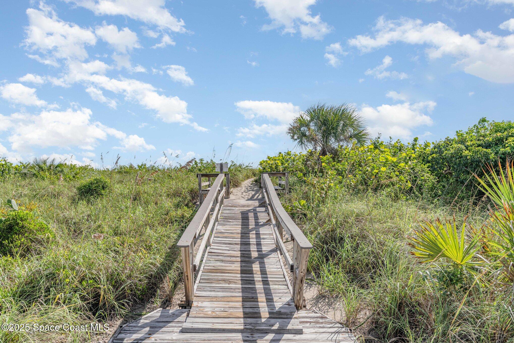5000 Ocean Beach Boulevard, Unit C5 Cocoa Beach, FL 32931 - Photo 26 of 31 a view of a pathway both side of building
