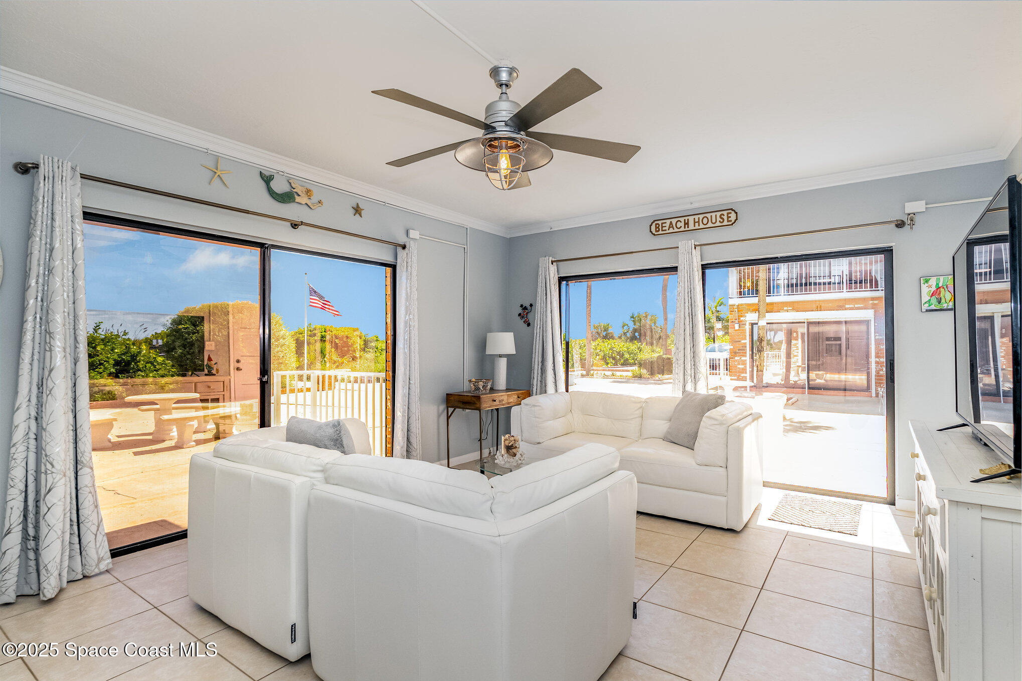 5000 Ocean Beach Boulevard, Unit C5 Cocoa Beach, FL 32931 - Photo 9 of 31 a living room with furniture and a large window