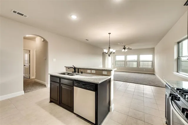 a kitchen with a stove and a wooden cabinets