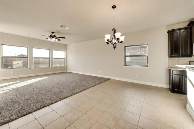 a kitchen with kitchen island granite countertop stainless steel appliances a stove sink microwave and cabinets