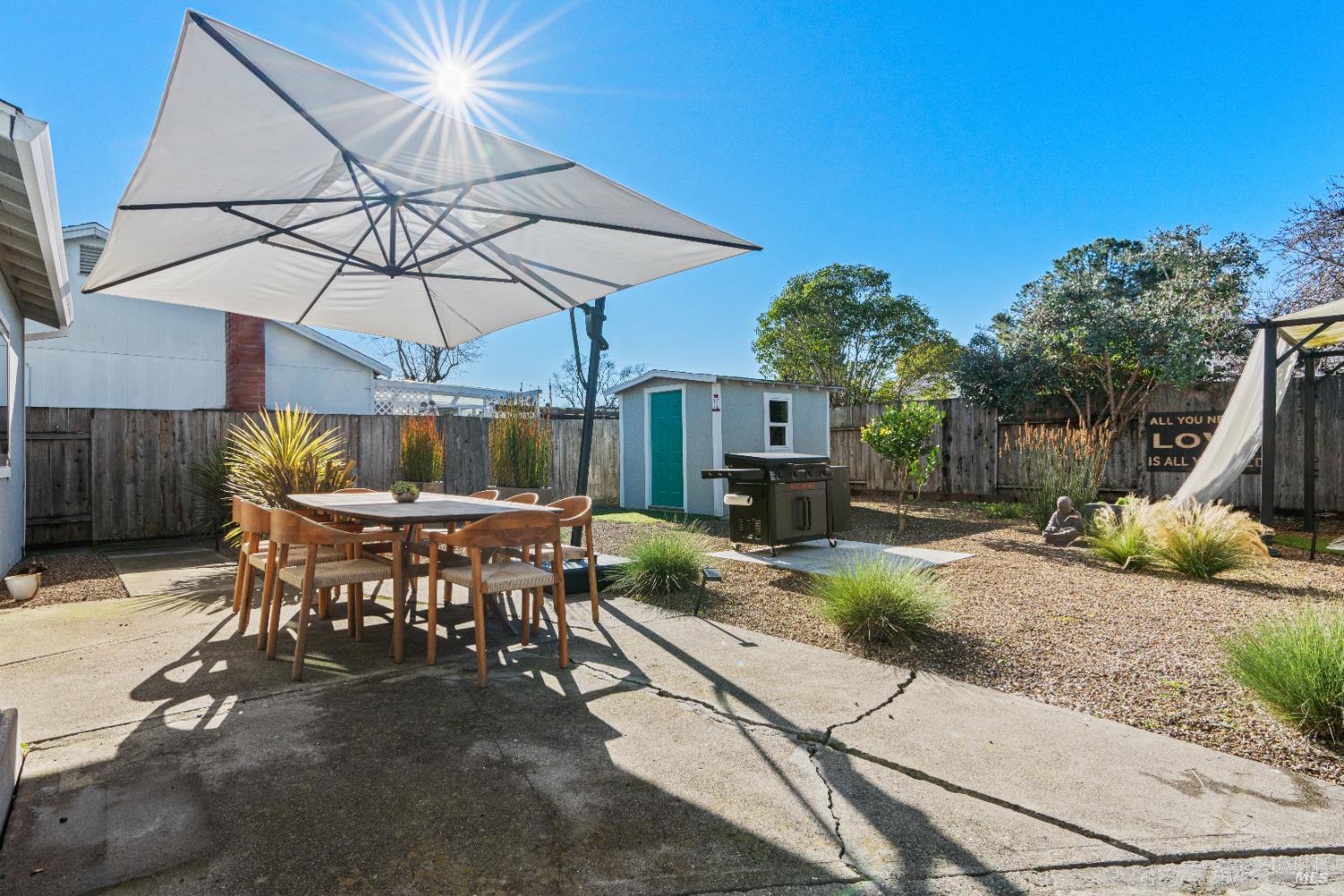8633 Lancaster Drive Rohnert Park, CA 94928 - Photo 16 of 66 a patio with a table and chairs under an umbrella