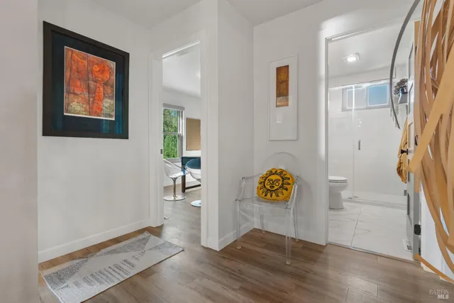 a bathroom with a sink a mirror a vanity and a shower