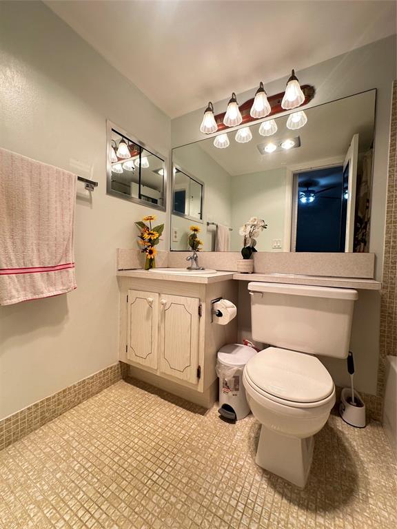 84 Farnham East, Unit 84 Deerfield Beach, FL 33442 - Photo 16 of 57 a bathroom with a granite countertop toilet sink and mirror