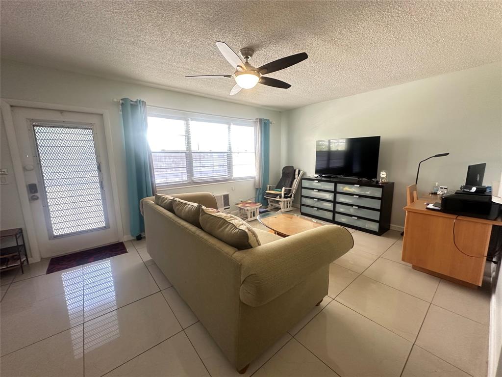 84 Farnham East, Unit 84 Deerfield Beach, FL 33442 - Photo 3 of 57 a living room with furniture and a flat screen tv
