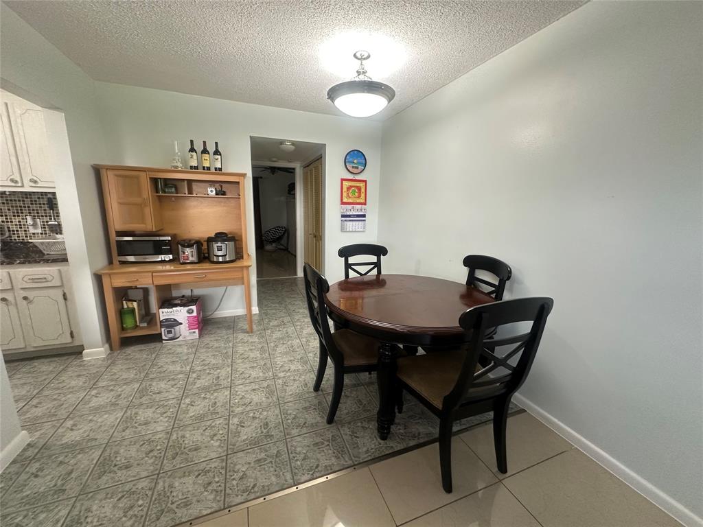 84 Farnham East, Unit 84 Deerfield Beach, FL 33442 - Photo 6 of 57 a view of a dining room with furniture and a chandelier