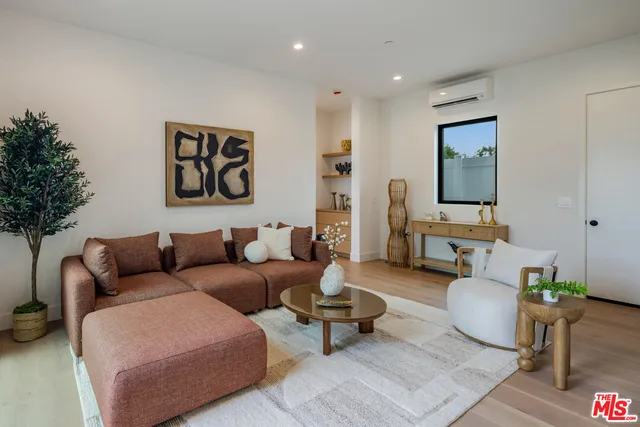 a bedroom with a bed and a view of balcony