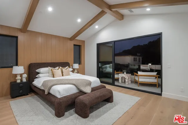 a bedroom with a bed and large window