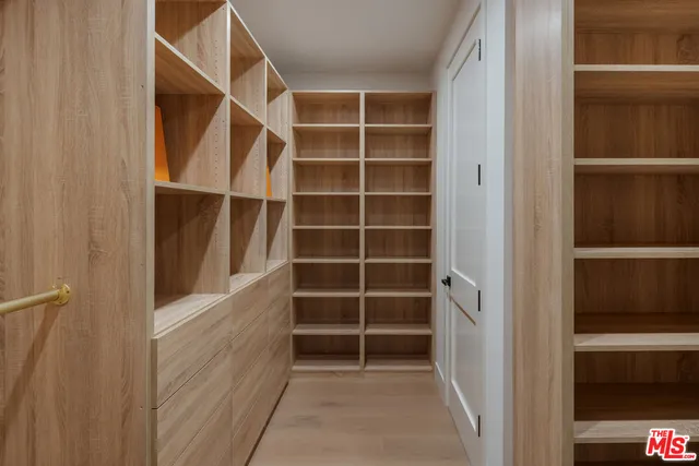 a bathroom with a double vanity sink mirror and cabinets